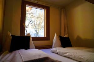 a bedroom with two beds in front of a window at Seeblick in Arosa