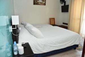 Postel nebo postele na pokoji v ubytování Hotel L'Initiale