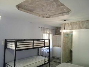 a bedroom with a bunk bed with a ceiling at Kostis Hause in Kastrákion