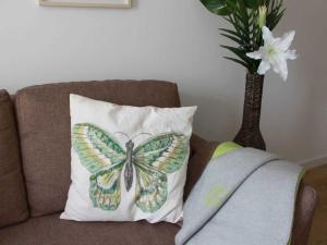 a butterfly pillow sitting on top of a couch at Residenz Haffblick Wohnung 31 in Boltenhagen
