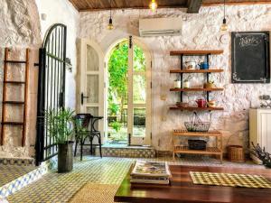 a room with a stone wall with a blackboard at Original stone house with patio in the city center in Alacati