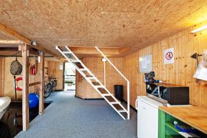 a room with a ladder in the middle of a kitchen at Bootshaus Am Müritzarm in Vipperow +20 photos