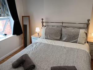 a bedroom with a large bed with a window at welcome to this flat in Kettering