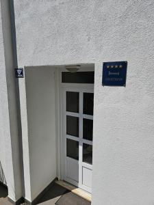 a door to a building with a sign above it at Apartment Hajdi in Podstrana