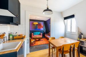 a kitchen with a table and a dining room at GuestReady - Spacious Bright flat near Louvre in Paris