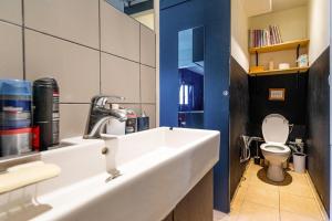 a bathroom with a sink and a toilet at GuestReady - Spacious Bright flat near Louvre in Paris