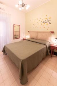 a bedroom with a large bed in a room at La Casetta di Giò! in Castellammare del Golfo