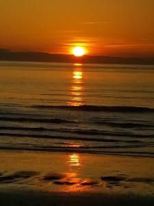 a sunset on the beach with the sun setting at Domaine de la lumière in Saint-Jean-de-Monts +5 photos