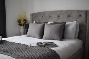 a bedroom with a bed with a book on it at Amazing 2BR in Brentwood in Brentwood