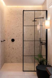 a shower with a glass door in a bathroom at Elysian Fields in Mġarr
