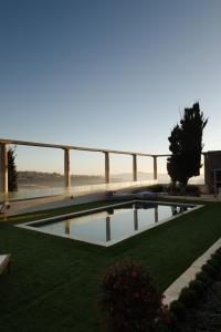 a swimming pool in the middle of a grassy field at Elysian Fields in Mġarr