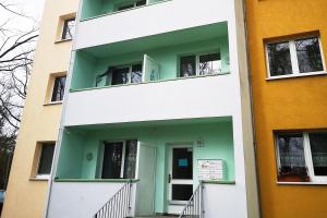 a building with a green door and windows at Cozy Apartment in Dessau-Roßlau in Dessau