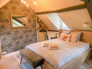 a bedroom with a bed with a mirror on the wall at Clementines House Honfleur in Honfleur