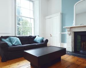 a living room with a couch and a coffee table at Arlington Villas Townhouse by Clifton Short Lets in Bristol