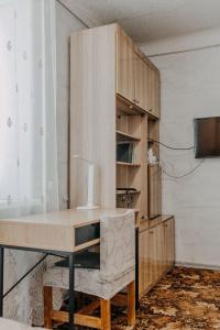 a wooden desk with a lamp on it in a room at Comfortable apartments on Hrushevskogo street near 16 city hospital in Dnipro