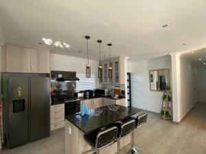 a kitchen with a black counter top in a room at 32 On Gill Road Self Catering in Cape Town
