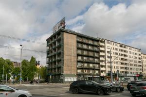 a large building with cars parked in a parking lot at Warsaw Concierge Grójecka View in Warsaw