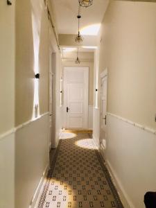 a hallway with a tile floor and a white door at Oh ! Cairo Hostel in Cairo
