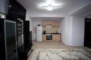 a kitchen with a white refrigerator and a stove at Alex 1 Apartament in Iaşi