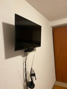 a flat screen tv hanging on a wall at Apartmani Rakocevic in Sutomore