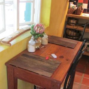 a wooden table in a kitchen with a tub at Sol Y Sombra in Bettyʼs Bay