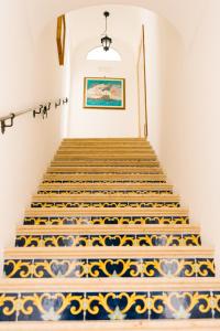 a stairway with blue and white tiles at Villa Principe Giovanni in Positano