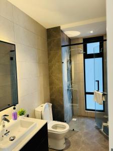 a bathroom with a toilet and a sink and a shower at Axon Residence By TS in Kuala Lumpur