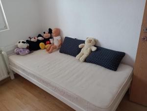 a bed with stuffed animals sitting on top of it at L&L in Sarajevo