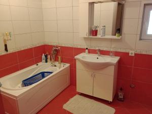 a bathroom with a bath tub and a sink at L&L in Sarajevo