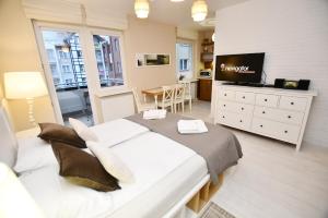 Televízia a/alebo spoločenská miestnosť v ubytovaní Apartamenty NAVIGATOR-PORT