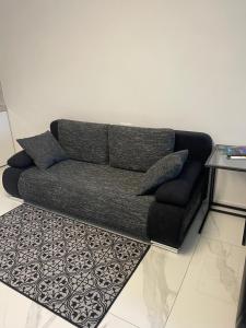 a couch in a living room with a rug at City Apartment in Bad Säckingen