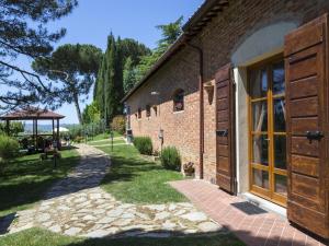 a brick building with a large window and a walkway at Villa Camelia in Cortona