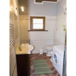 a bathroom with a sink and a washing machine at Villa Camelia in Cortona +19 photos