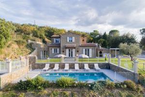 an estate with a swimming pool in front of a house at Villa Chiara in Cortona