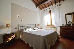 a bedroom with a large bed and a window at Casa I Pini in Cortona +32 photos
