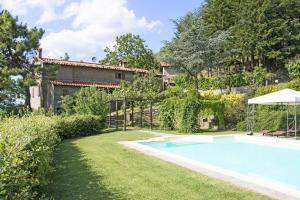 an outdoor swimming pool in the yard of a house at Villa Magnolia in Cortona