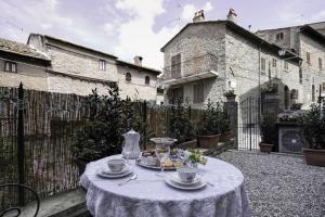 einen Tisch mit Teller Essen auf dem Hof in der Unterkunft Casa Caterina in Cortona