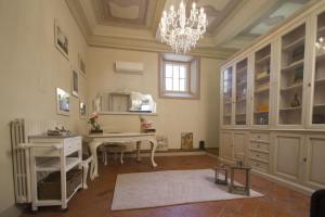 a home office with a desk and a chandelier at Cortona Suite in Cortona