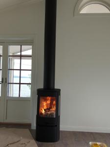 a fireplace in the corner of a room at Ferienhaus für 5 Personen ca 100 qm in Rensbyn, Mittelschweden See Runn in Falun