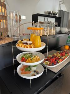 a buffet with three plates of food on a counter at Schloß Ort in Passau