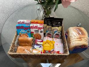 a basket of food and bread on a glass table at ElMurrs in Bournemouth