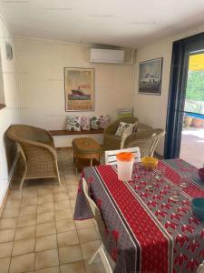 a room with a table and chairs and a couch at Appartement 2 chambres - 4 personnes 4HD47 in Collioure