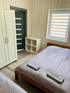 Postel nebo postele na pokoji v ubytování Palūšės Kempingas (nameliai)