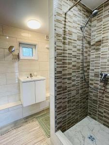 a bathroom with a shower and a sink at Palūšės Kempingas (nameliai) in Palūšė