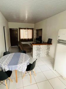 uma cozinha com mesa e cadeiras num quarto em Casa em Sinop em Sinop