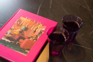 a book and a pair of glasses on a table at Veluwe Boutique Lodge in Putten
