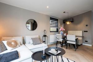 a living room with a white couch and a table at Veluwe Boutique Lodge in Putten +49 photos