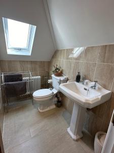 a bathroom with a toilet and a sink at ElMurrs in Bournemouth