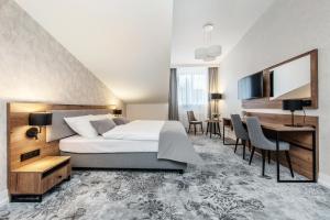 Ένα ή περισσότερα κρεβάτια σε δωμάτιο στο Vinfort Aparthotel