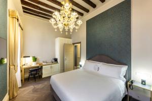 Postel nebo postele na pokoji v ubytování Hotel Palazzina Sardi